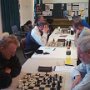 Cook ponders Power's knight outpost while Loveband - Murray focus intently on their game.
